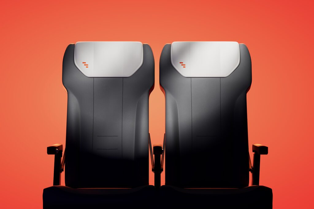Frontal artistic render of two seats in bold orange setup.