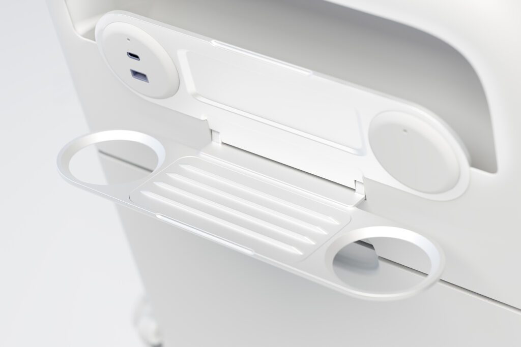 Render of white phone mount positioned above tray table on seat back.